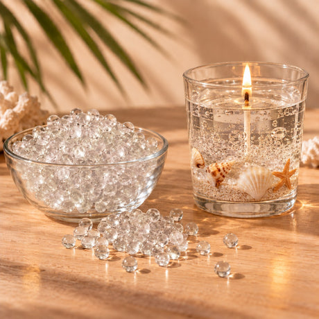 Perlas de cera de gel transparente para velas y vela de gel con conchas y arena encendida