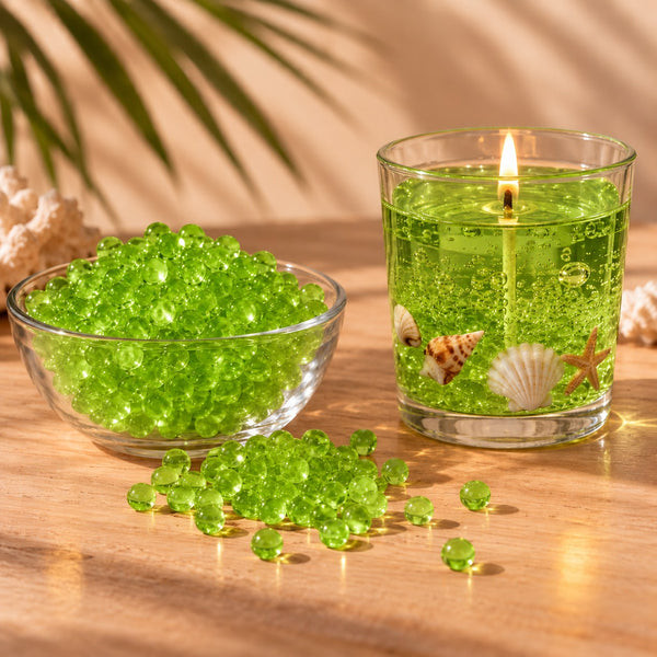 Perle di cera gel verde per candele in una ciotola e candela gel verde accesa con conchiglie