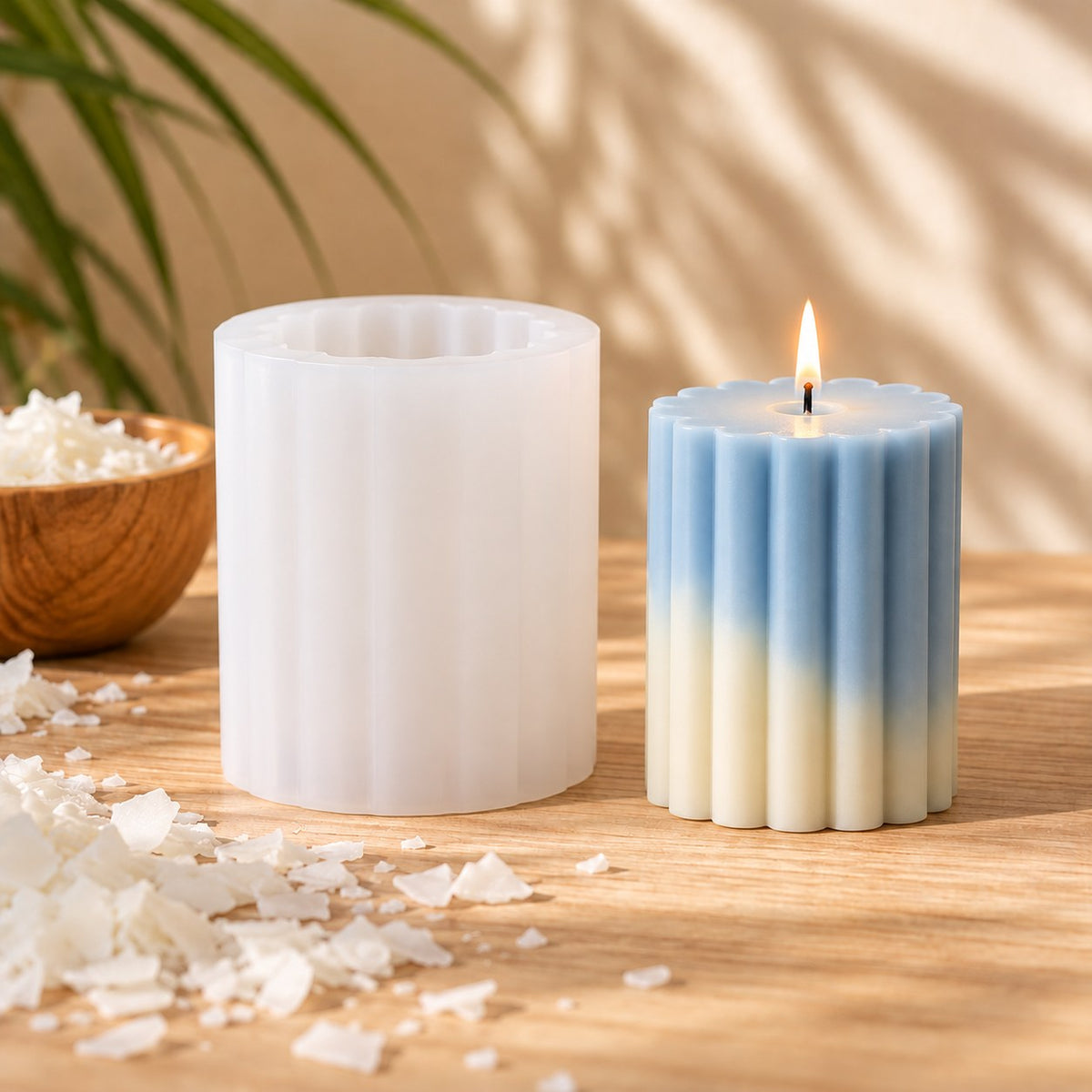 Molde de silicona estriado para velas con vela cilíndrica estriada azul y crema encendida - Naturcera